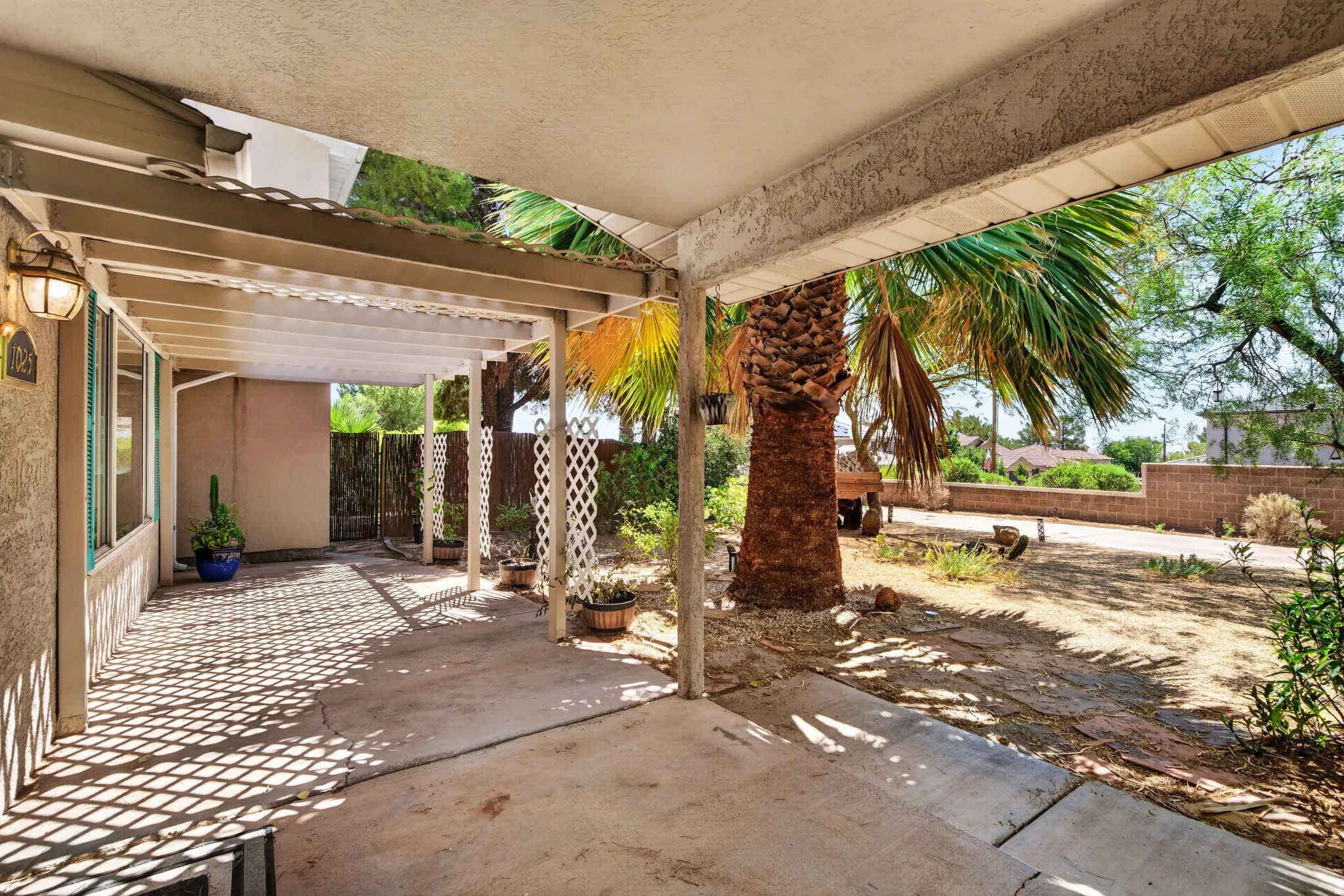Patio area featuring a partially covered concrete slab and an attached pergola structure