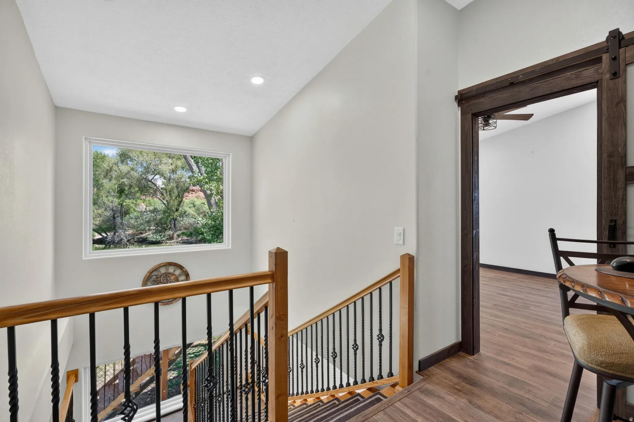 Staircase featuring wood handrails and decorative wrought iron spindles
