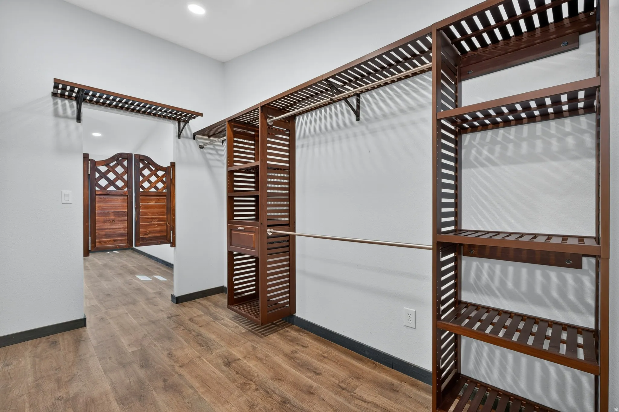 Built-in wood-finish shelving and hanging rods