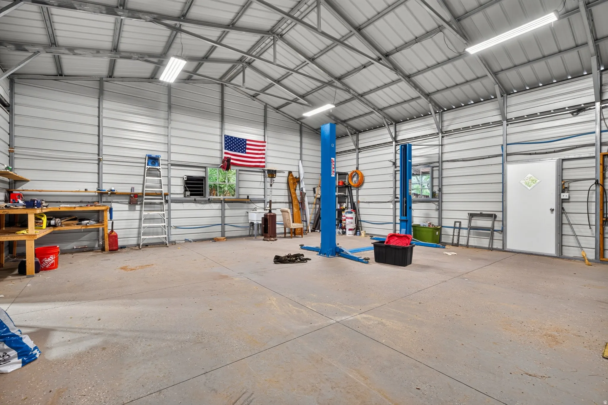 Spacious metal-frame building featuring a concrete slab floor and integrated lighting