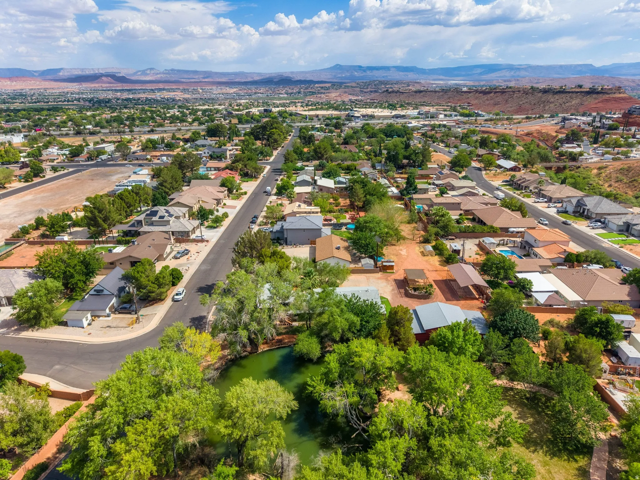 Aerial perspective showcasing a residential community with varied rooflines and established landscaping