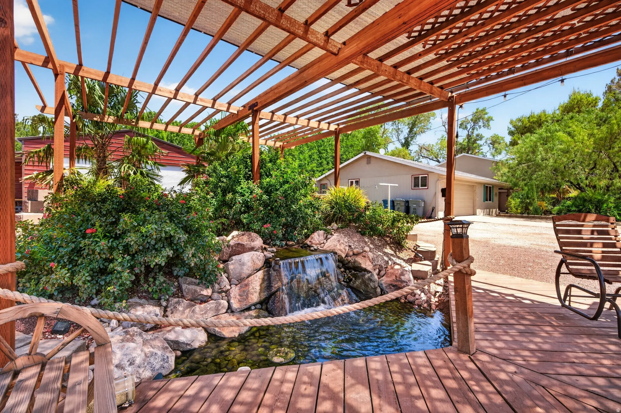 Expansive wood deck with an overhead pergola featuring a shade cover