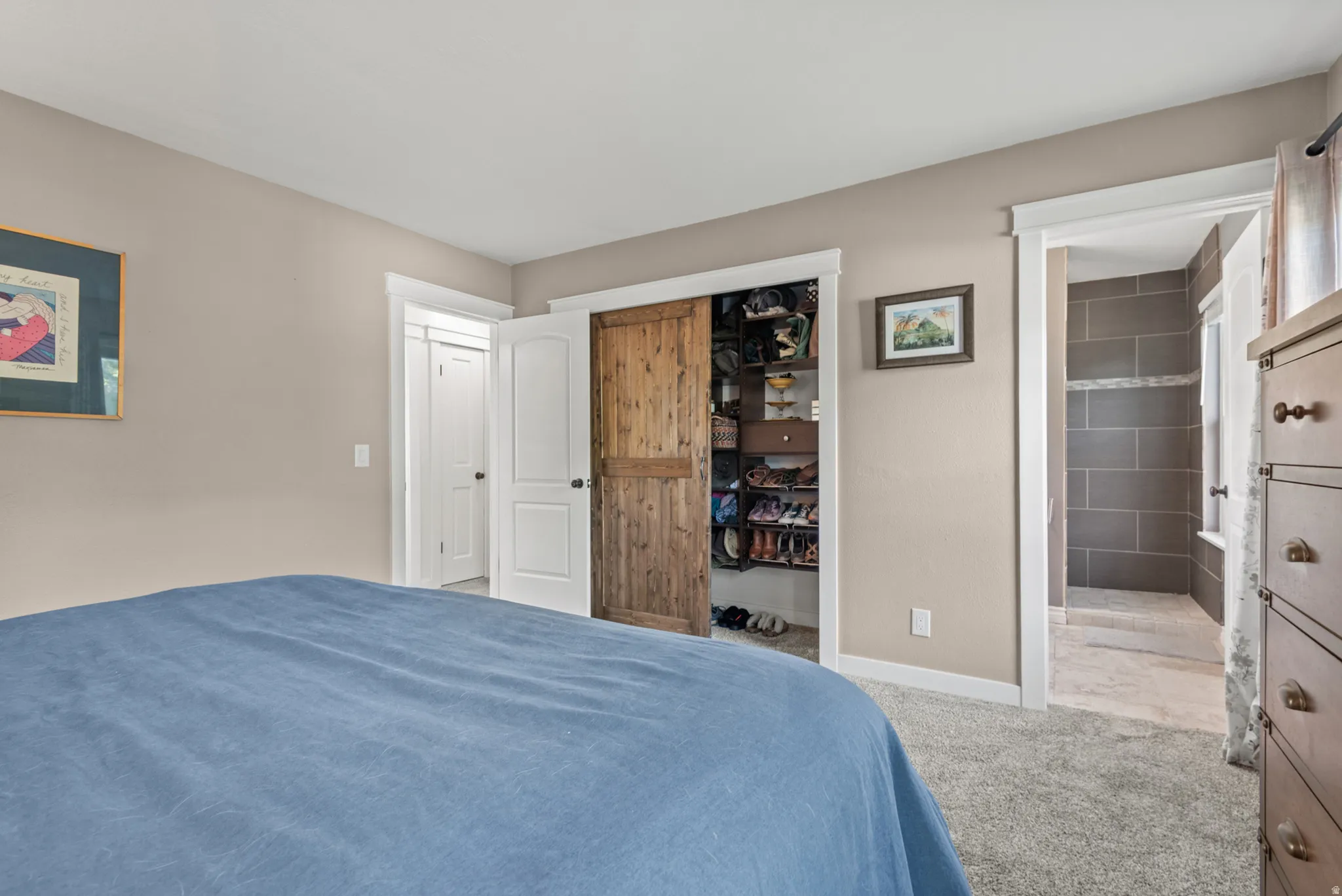 Neutral-toned walls, plush carpeting, and white trim accents