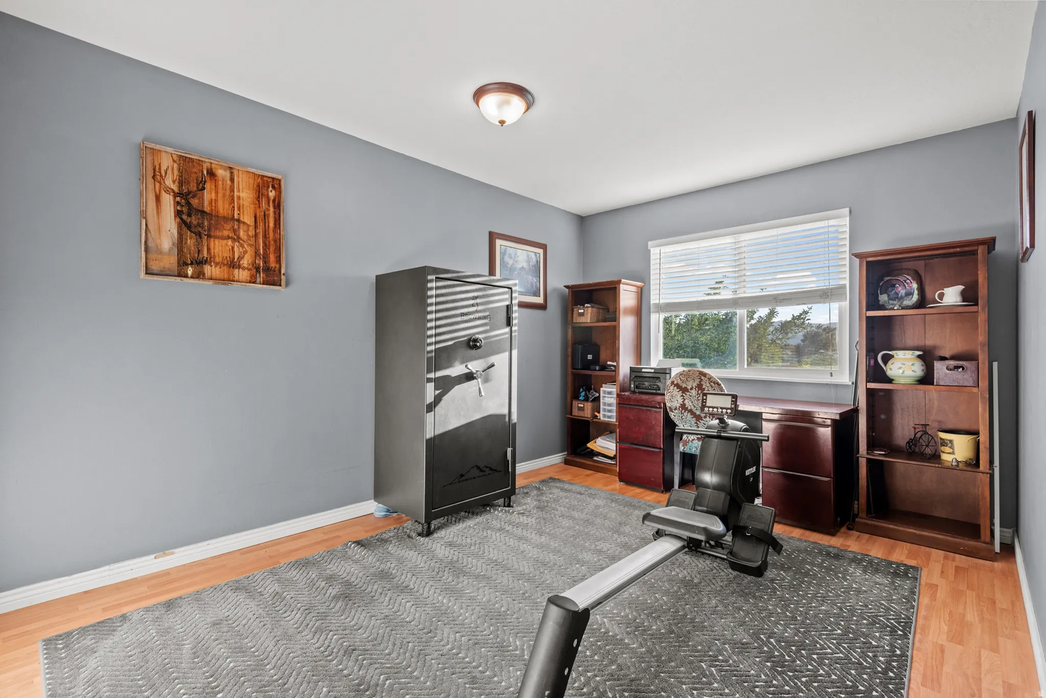 Light wood-finish flooring with a ceiling-mounted light fixture