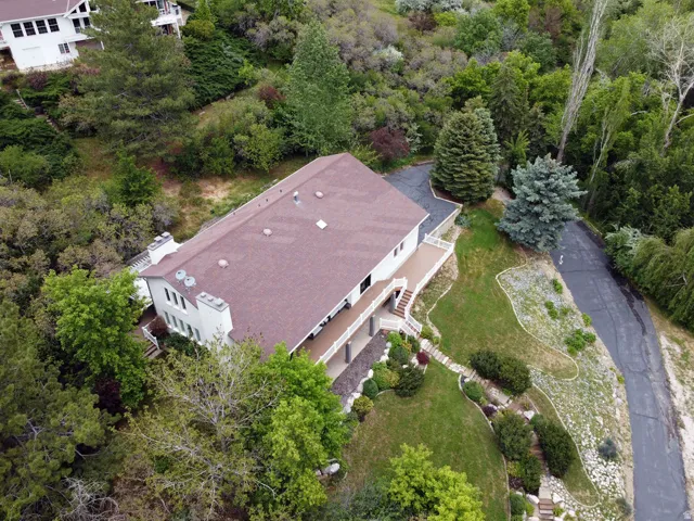 Aerial perspective showcasing a multi-level residence with a brown shingle roof