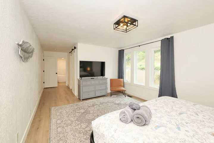Bright interior space featuring light wood-finish flooring, white walls, and a recessed ceiling light fixture