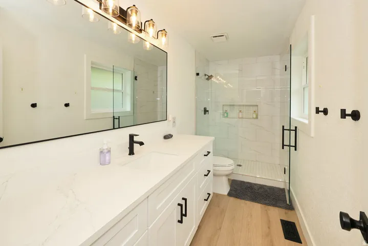 Contemporary bathroom featuring a dual vanity with a white countertop and rectangular undermount sinks