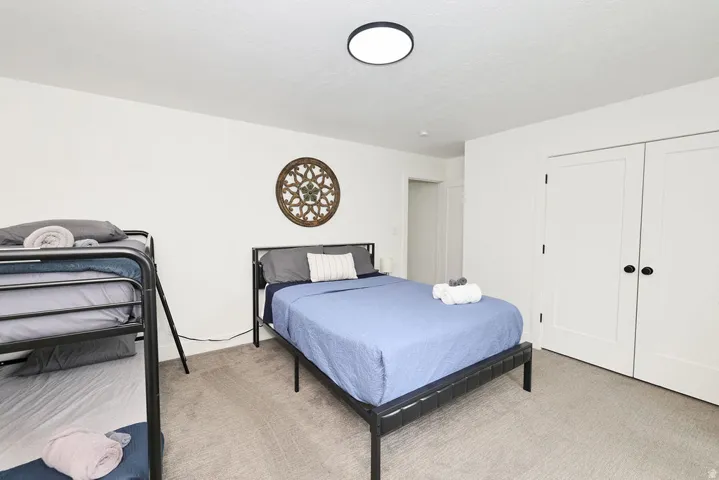 Spacious room featuring neutral carpeting and white walls