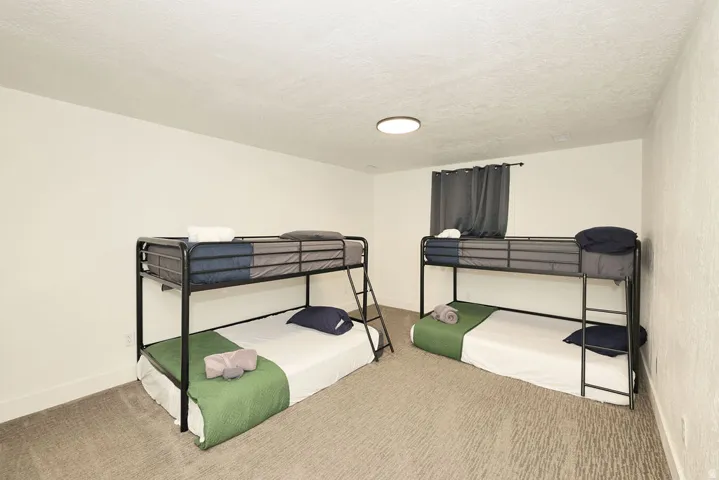 Room featuring white walls and textured wall paneling