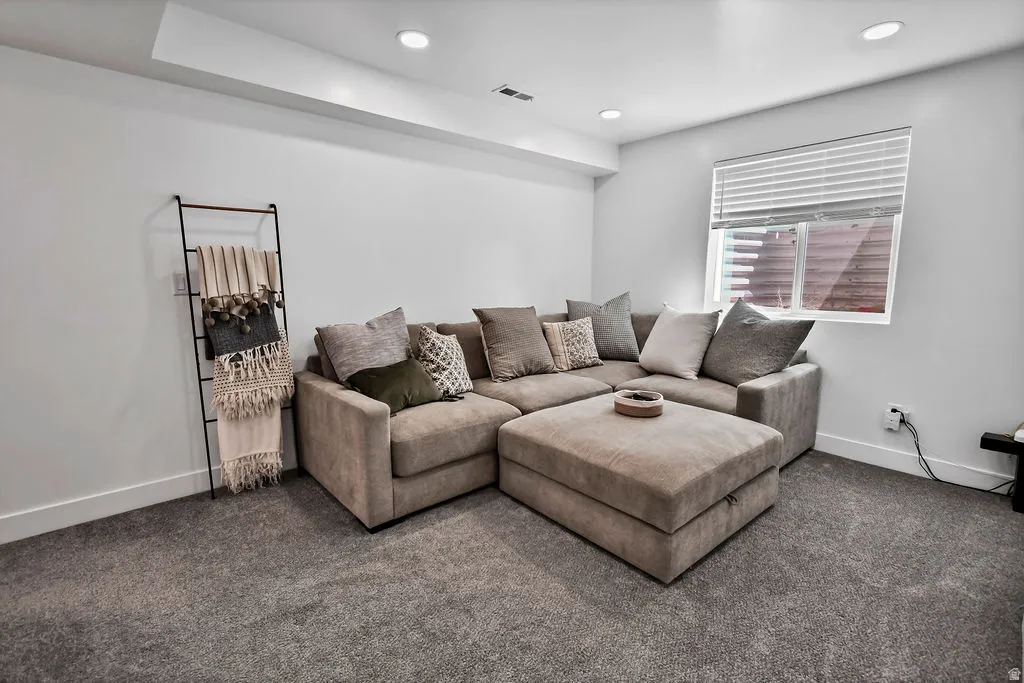 Finished room featuring recessed lighting, a single window with blinds, and light gray walls