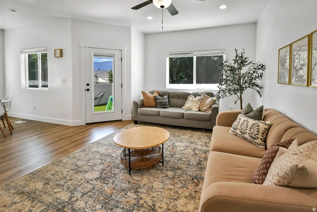 Open living area featuring wood-finish flooring, recessed lighting, and a ceiling fan