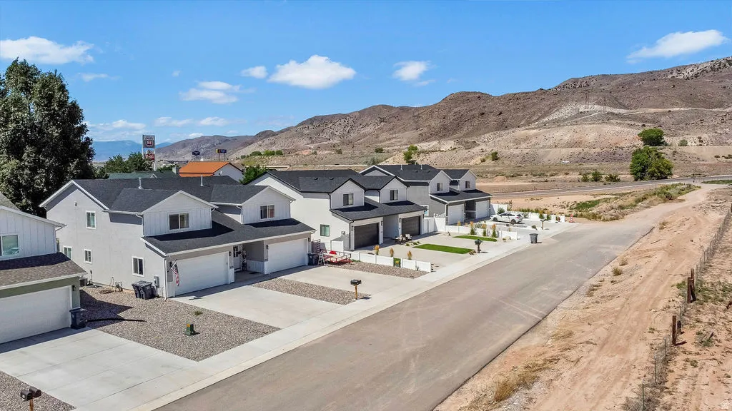 Modern residential properties featuring two-story stucco exteriors and attached garages