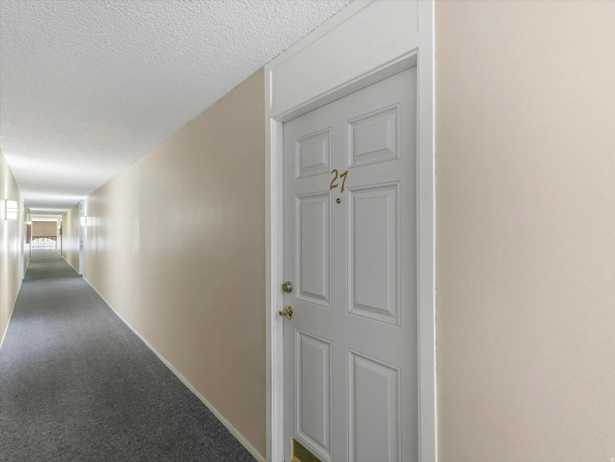 Entry door with brass-finish hardware and trim