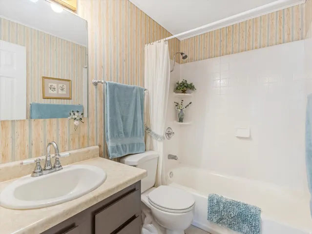 Full bathroom featuring a white tub-shower combination with white subway tile surround