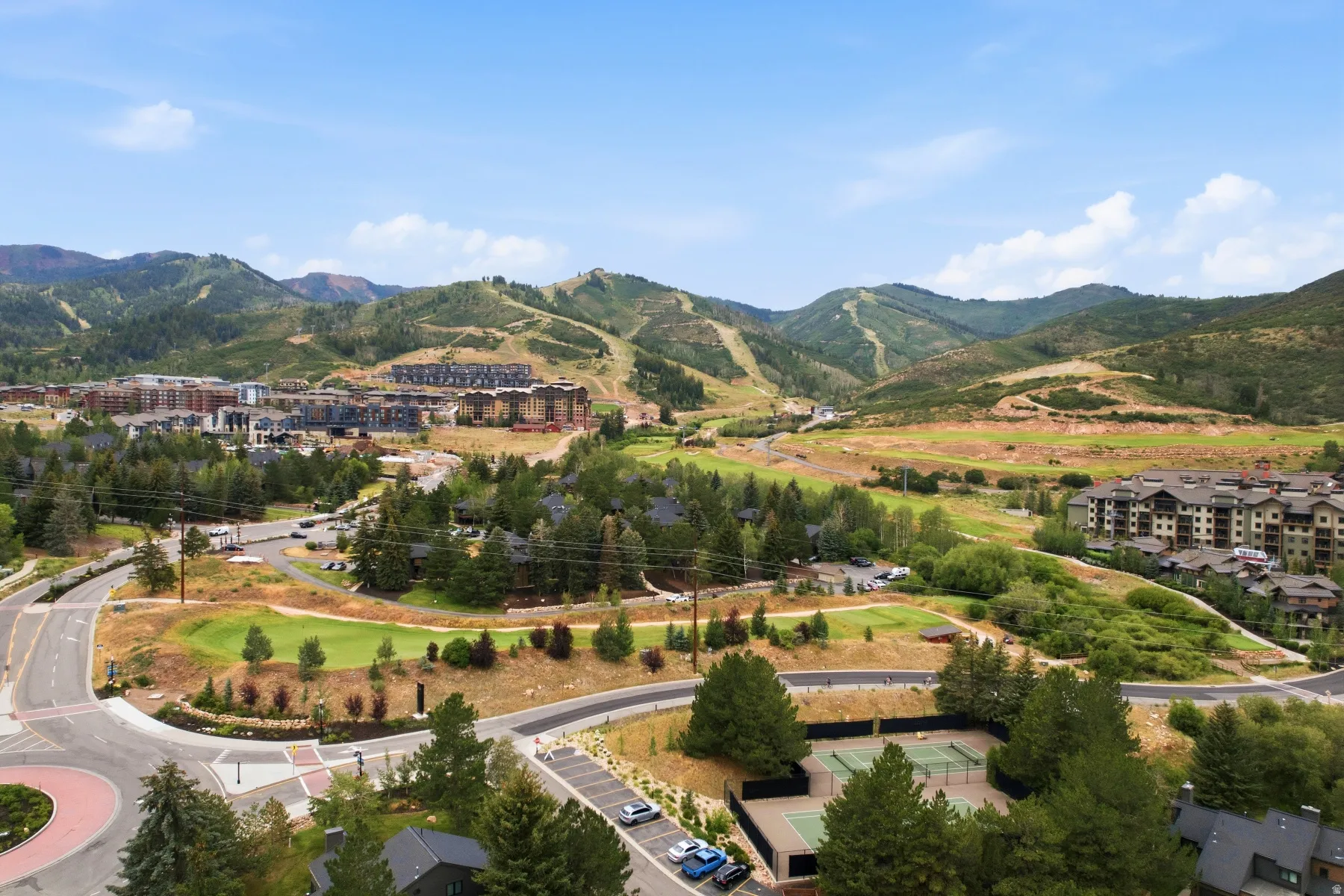 Expansive mountain landscape featuring residential communities, golf course, and tennis courts
