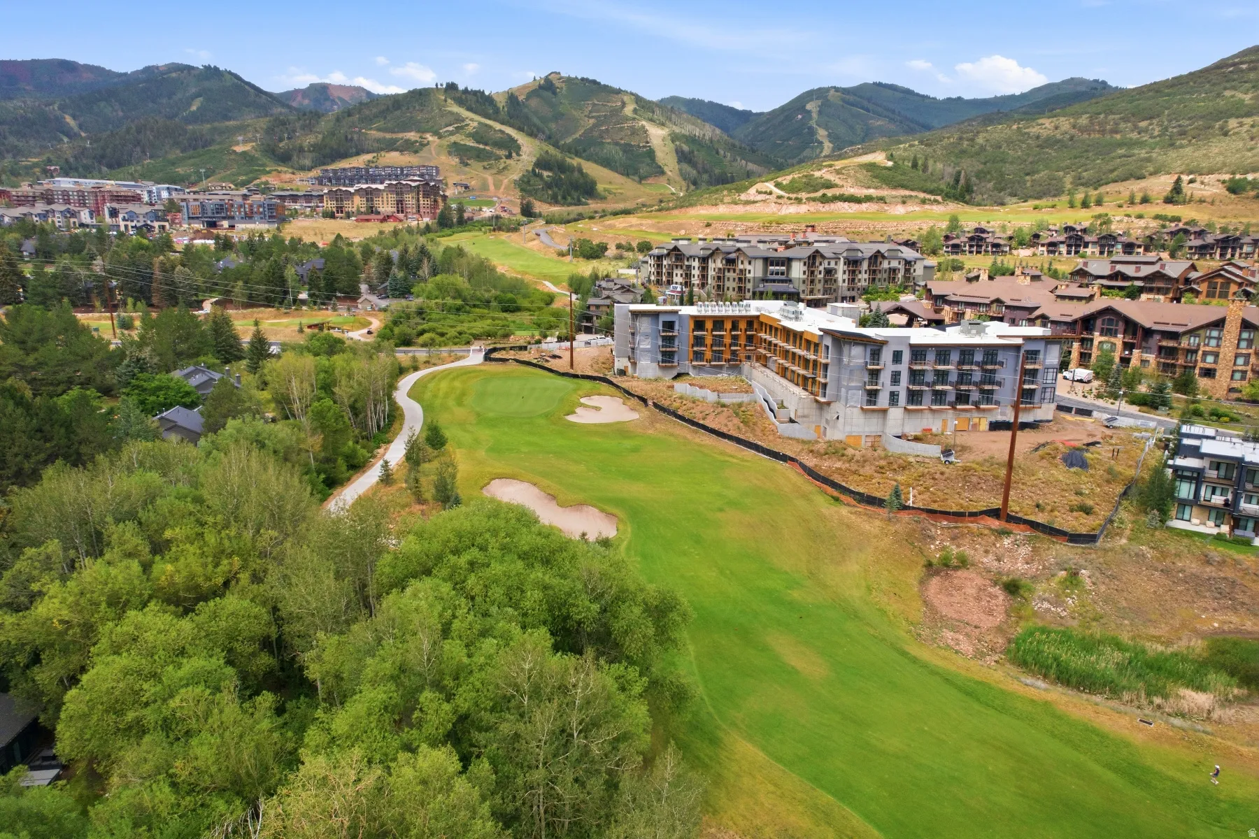 Expansive golf course featuring a manicured green and sand trap