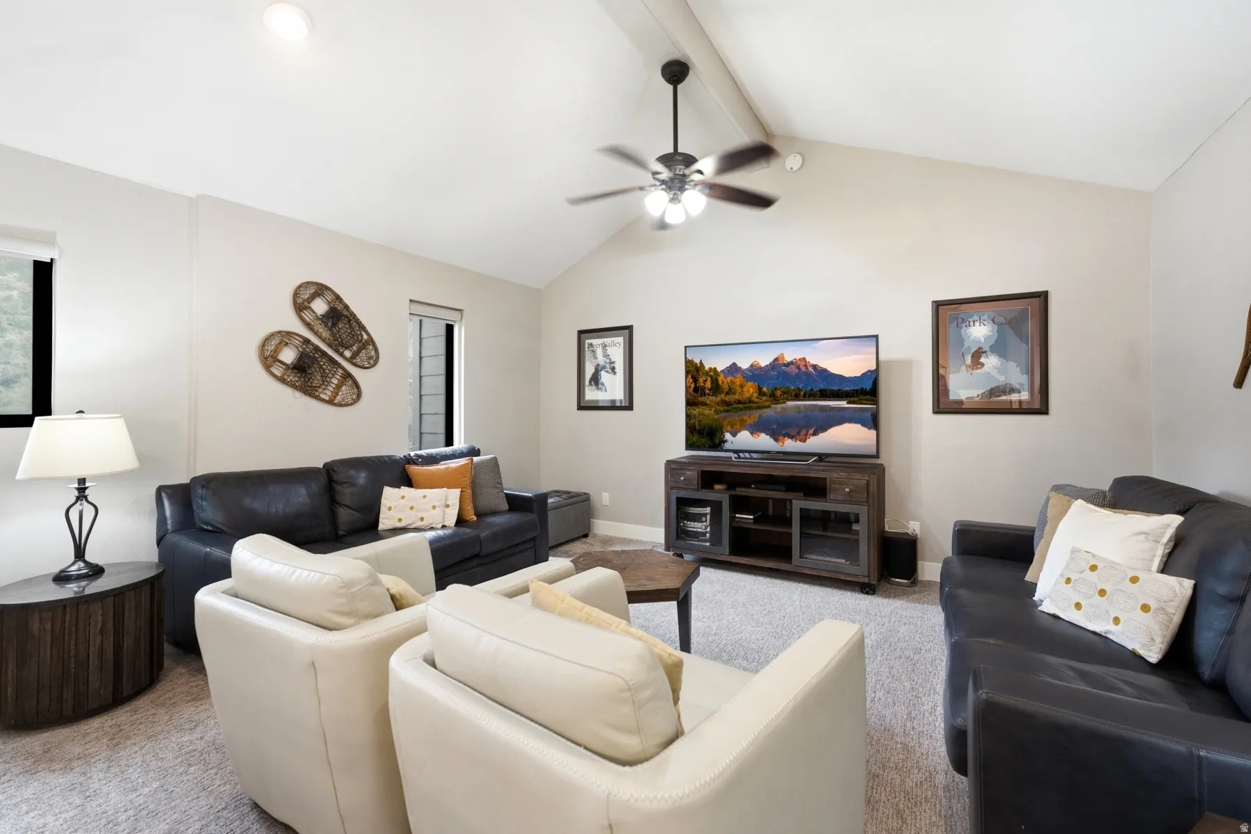 Vaulted ceiling living area featuring a ceiling fan with integrated lighting, recessed lighting, and light-toned walls