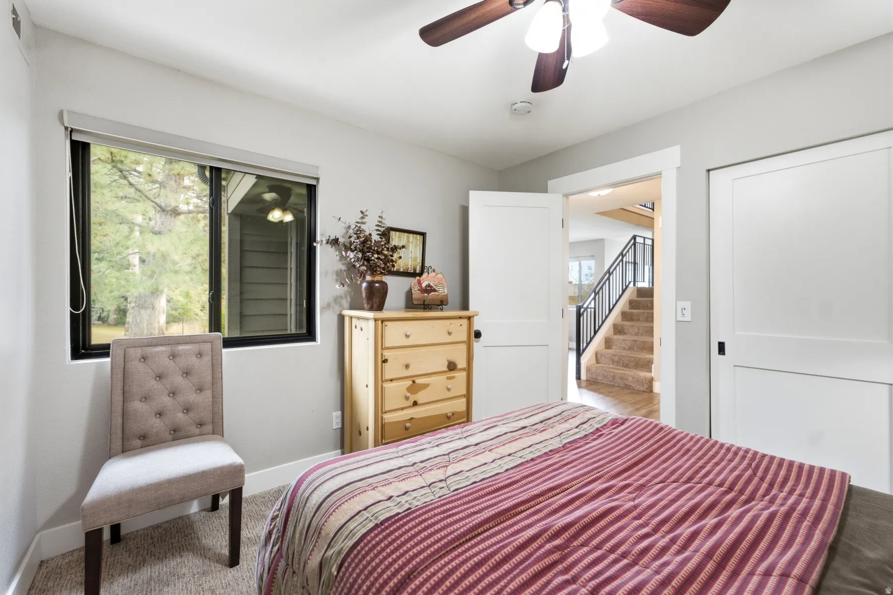 Room with light gray walls and carpeted flooring