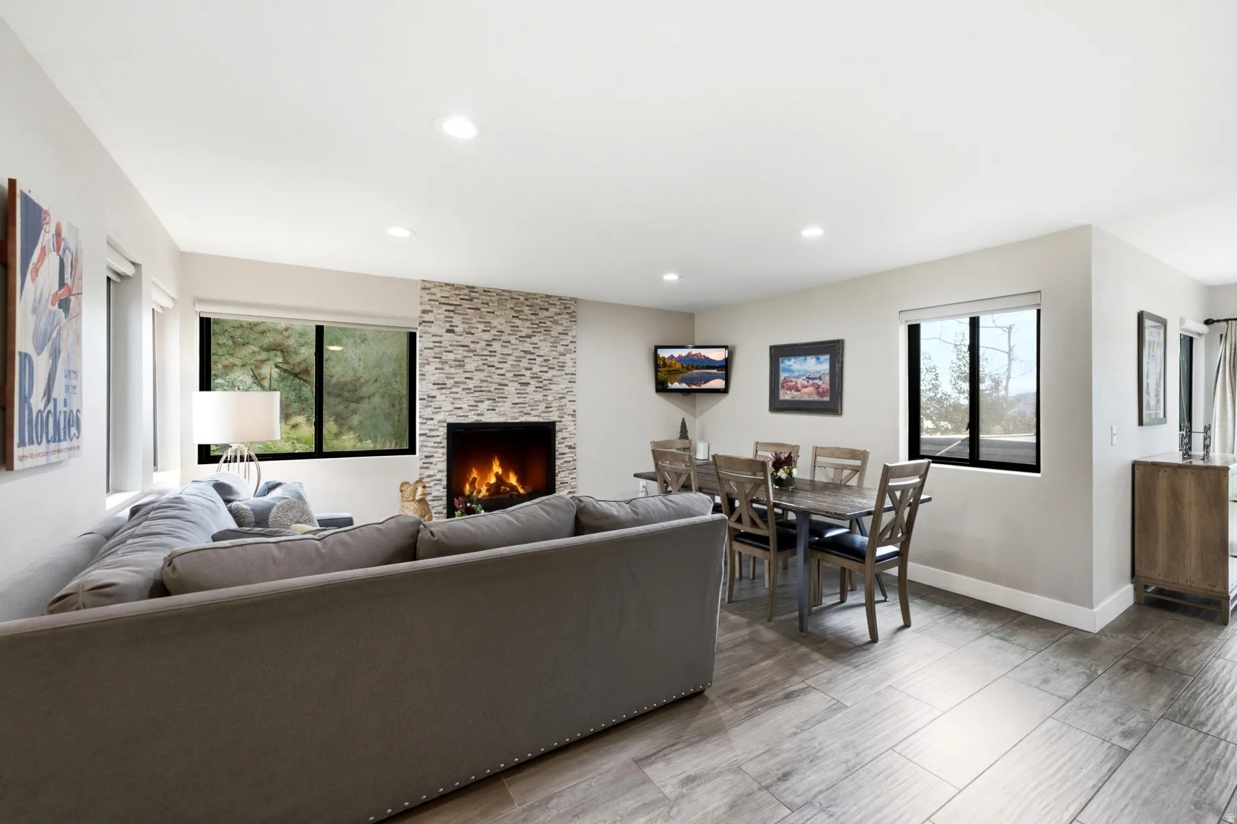 Spacious open-concept living area featuring wood-finish flooring and recessed lighting