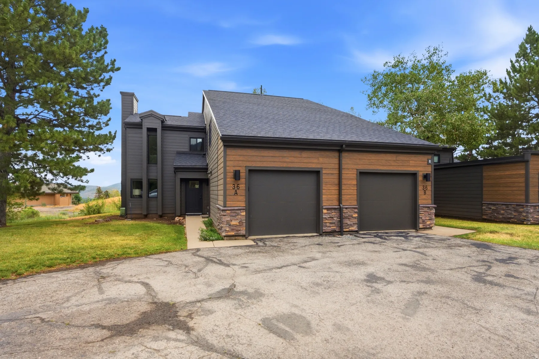 Multi-tone exterior featuring wood-tone siding and charcoal accents