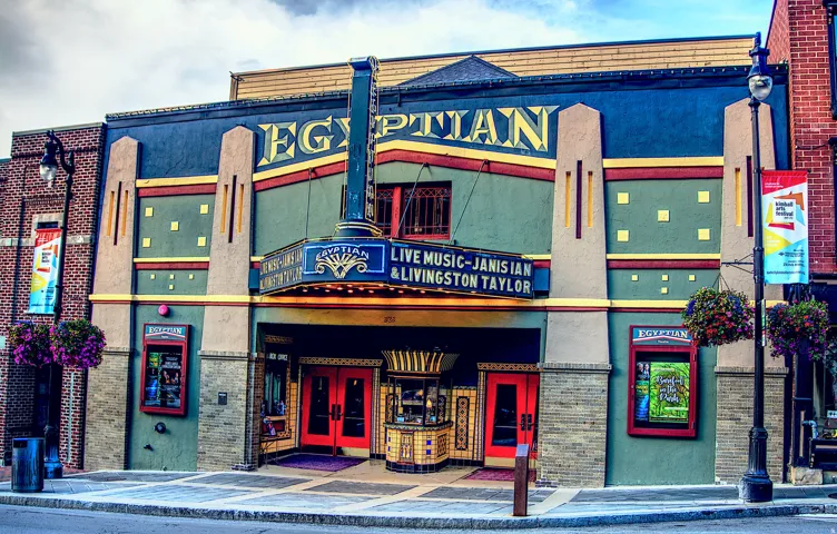 Art Deco-inspired facade featuring a prominent marquee sign and decorative gold lettering