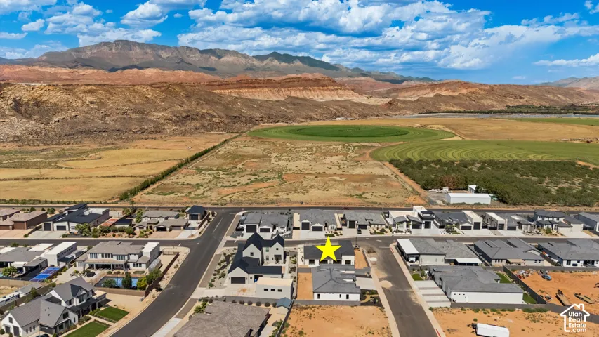 Expansive mountain backdrop with a residential street featuring modern-style homes