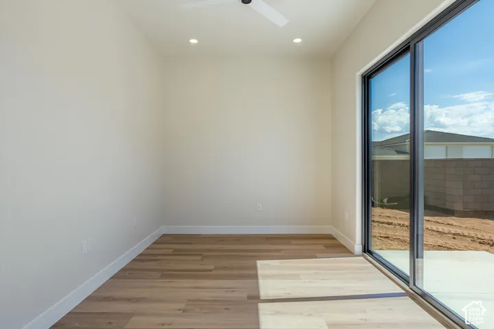 Recessed lighting, wood-finish flooring, white walls, and a ceiling fan