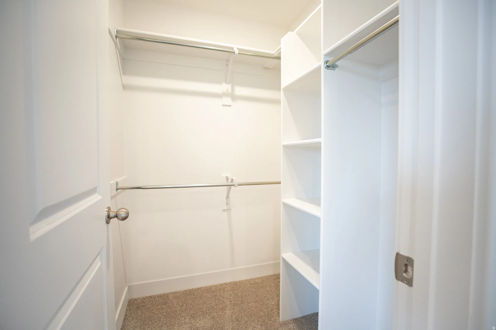 Walk-in closet with built-in shelving for the primary bedroom