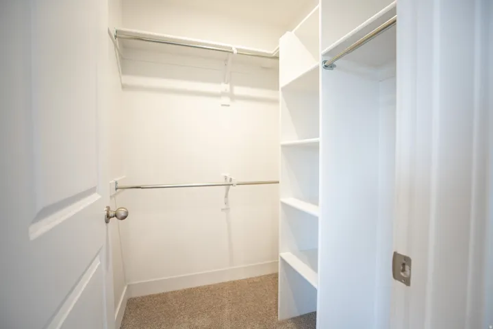Walk-in closet with built-in shelving for the primary bedroom