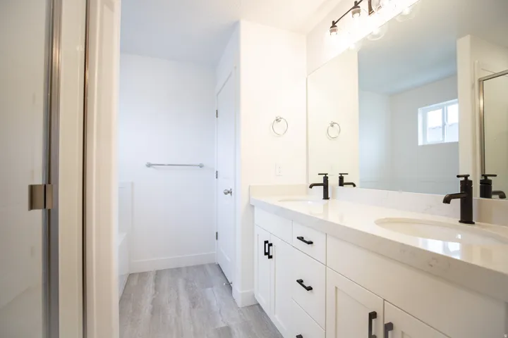 Primary bathroom with a separate tub and shower and a double vanity