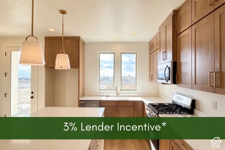 Kitchen featuring shaker-style cabinetry, solid-surface countertops, stainless steel appliances, pendant lighting, and wood-finish flooring