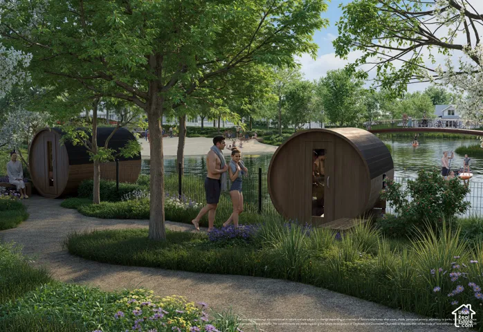 Paved pathways surrounded by landscaped plantings, barrel-style outdoor structures, and mature trees