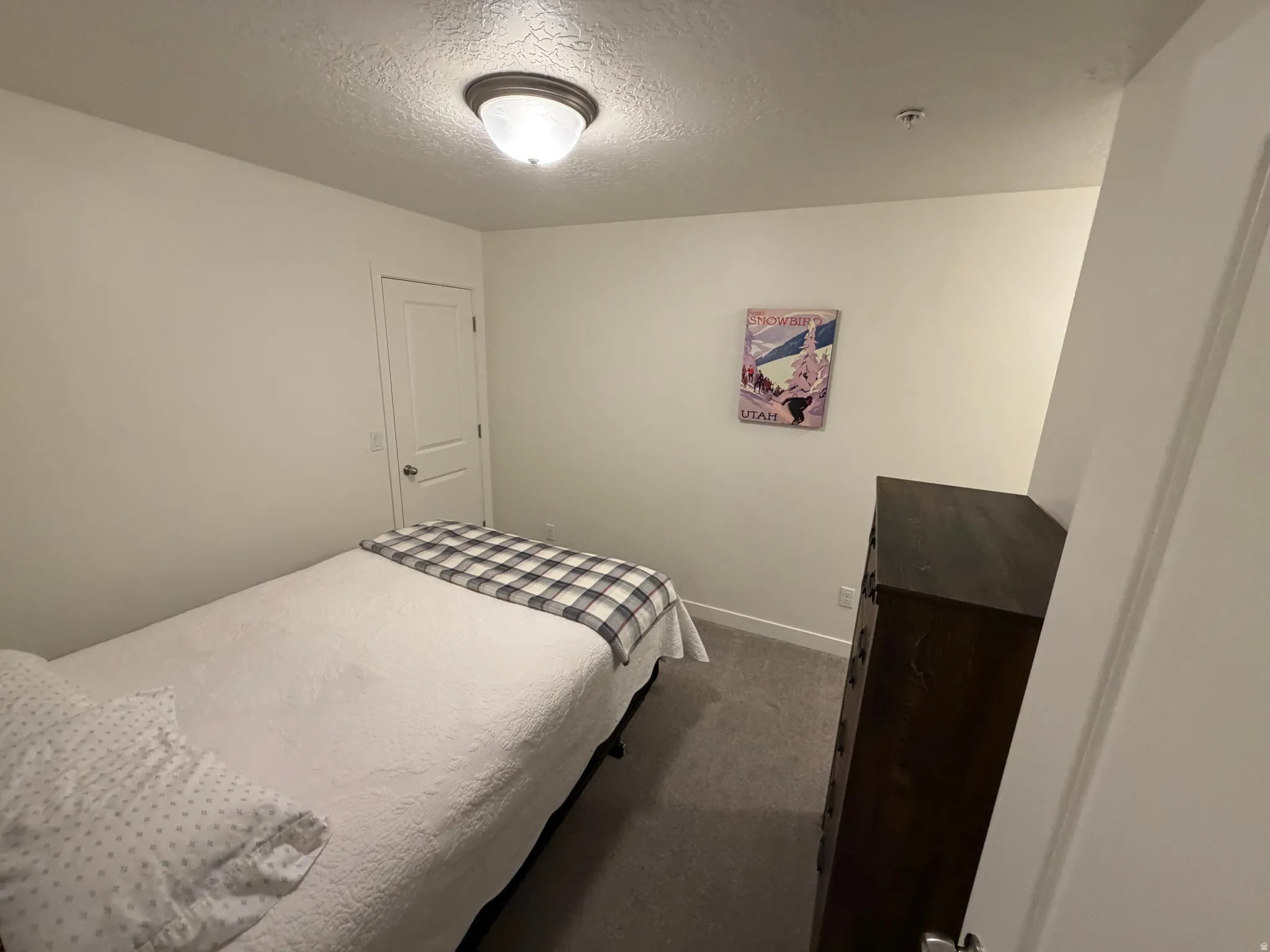 White painted walls and trim complement the gray carpeted flooring