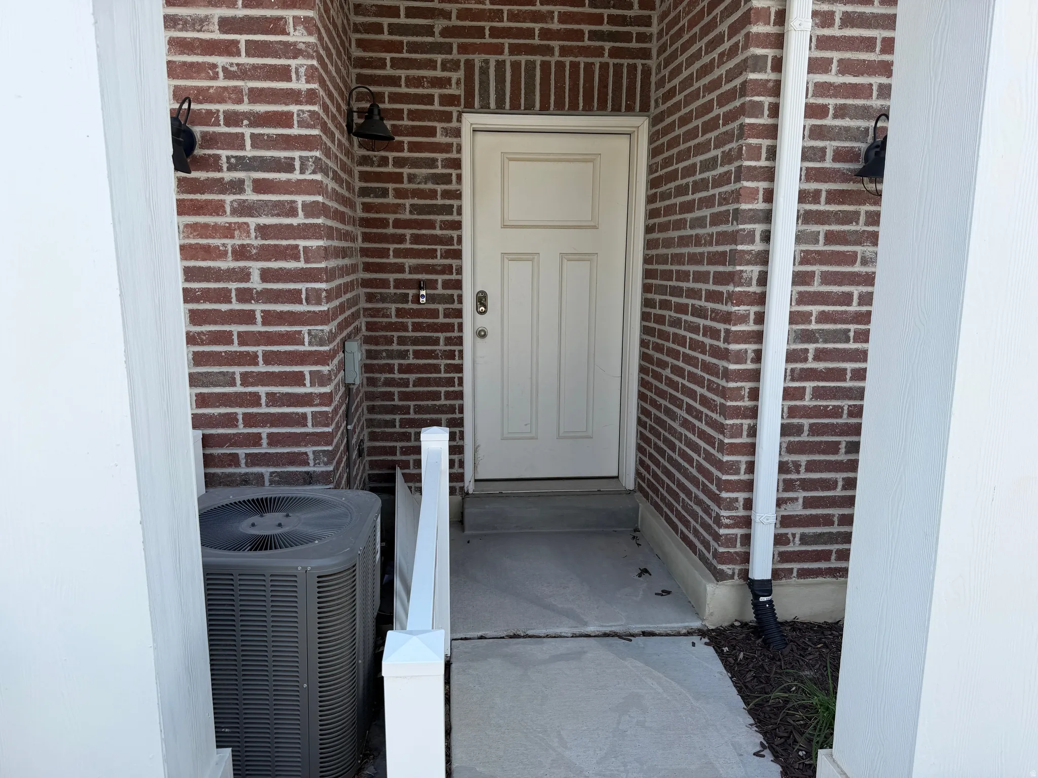 Brick exterior with white paneled door