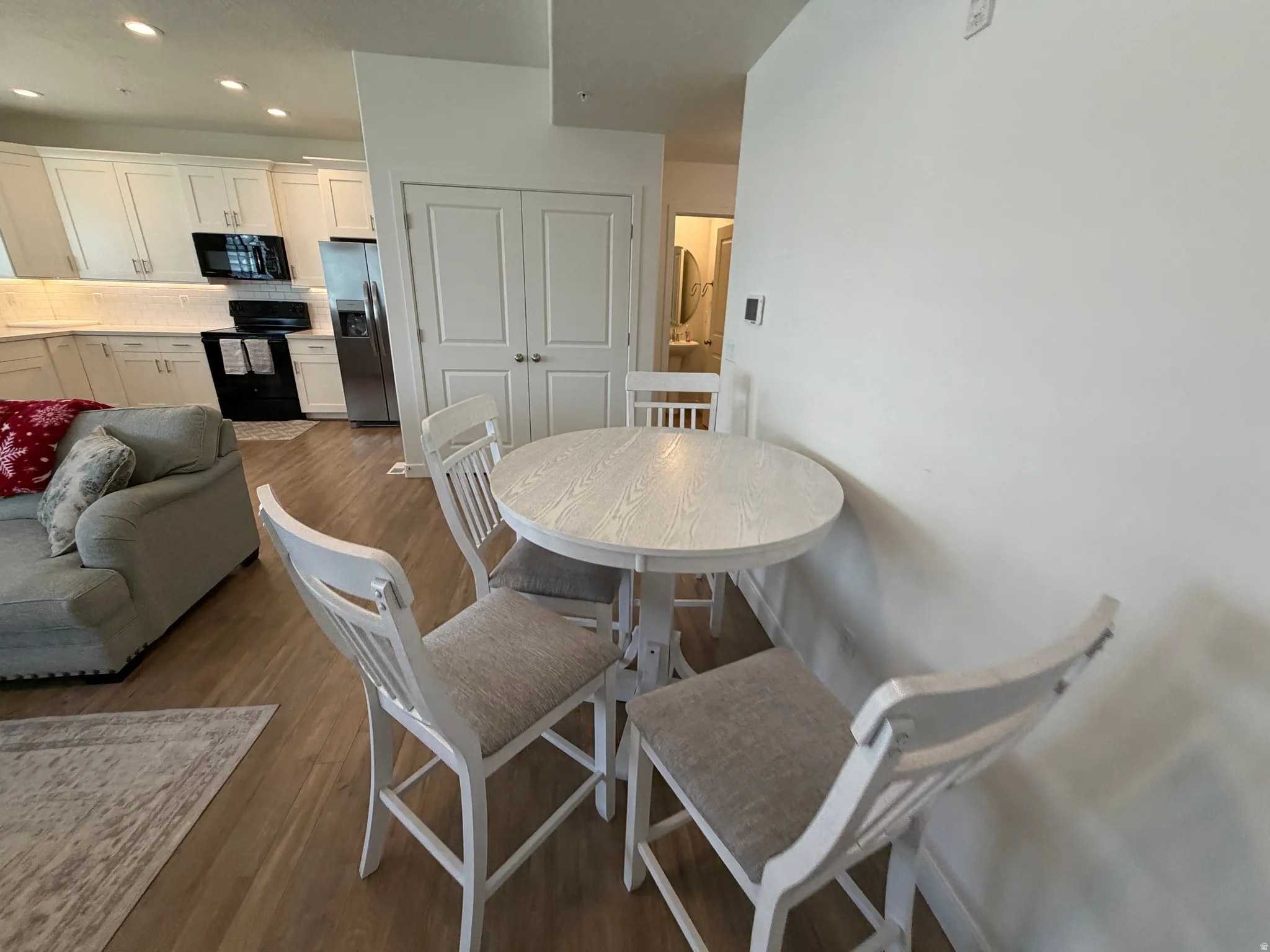 Open-concept living space with light wood-finish flooring