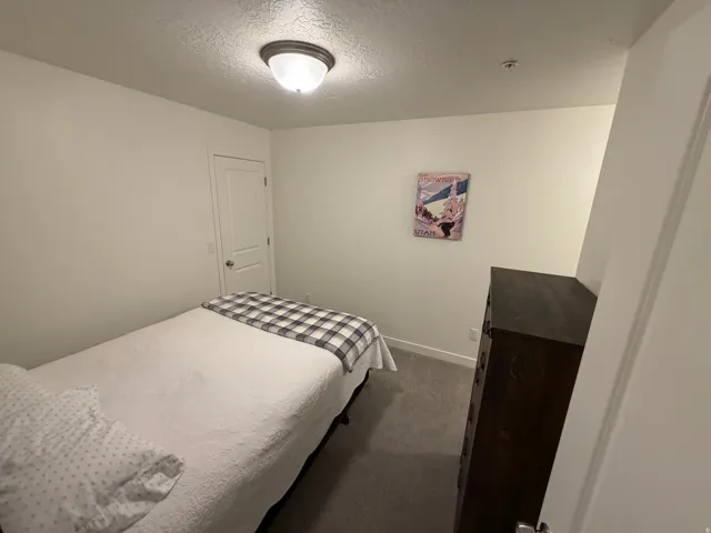 White painted walls and trim complement the gray carpeted flooring