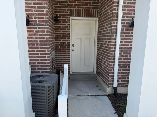 Brick exterior with white paneled door
