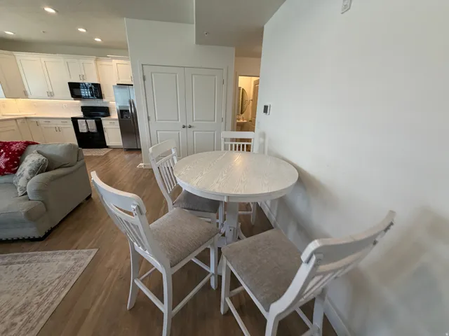 Open-concept living space with light wood-finish flooring