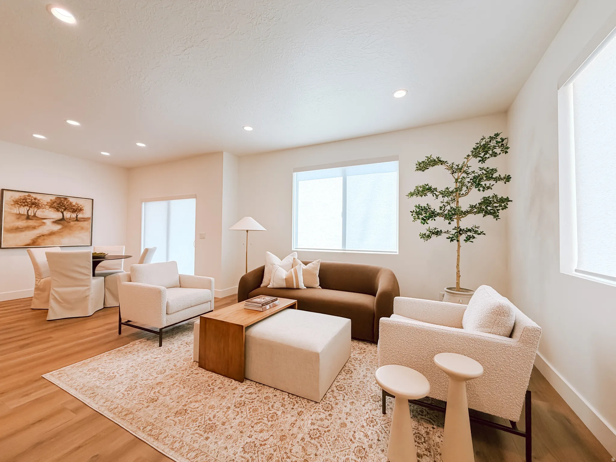 Open-concept living area with abundant natural light from multiple windows