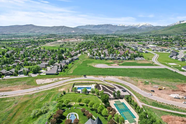 Expansive community grounds featuring a tennis court, a swimming pool, and a dedicated children's play area