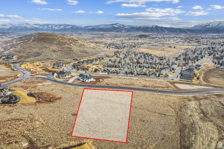 Expansive land parcel outlined in red, featuring a flat, buildable surface