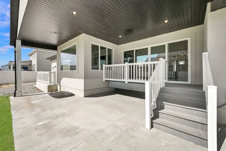 Covered patio with recessed lighting, concrete flooring, and a deck with white railings