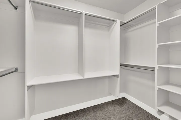 Built-in white shelving system with multiple compartments