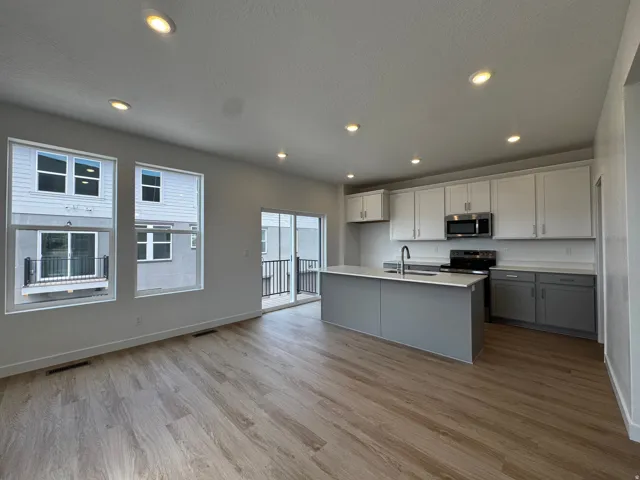 Open-concept living space with wood-finish flooring