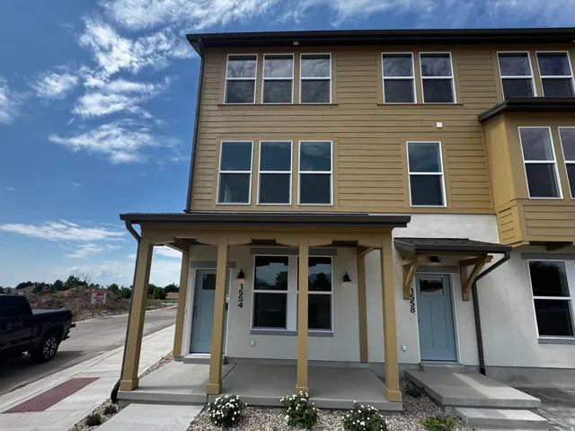 Multi-story facade featuring horizontal siding and stucco finishes