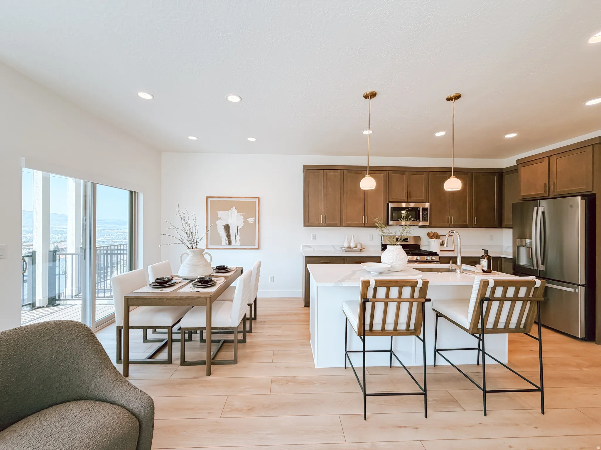 Open-concept kitchen and dining area featuring light wood-finish flooring