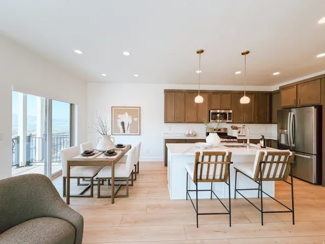 Open-concept kitchen and dining area featuring light wood-finish flooring