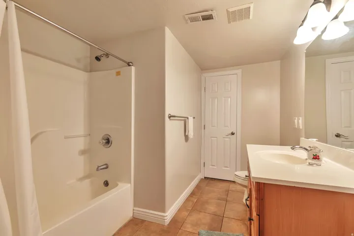 Bathroom featuring a light wood-finish vanity with a white countertop and integrated sink