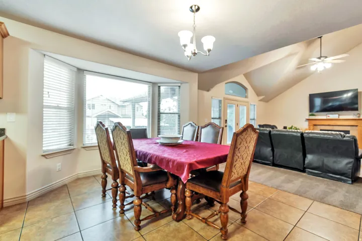 Dining area featuring bay windows with blinds and tile flooring