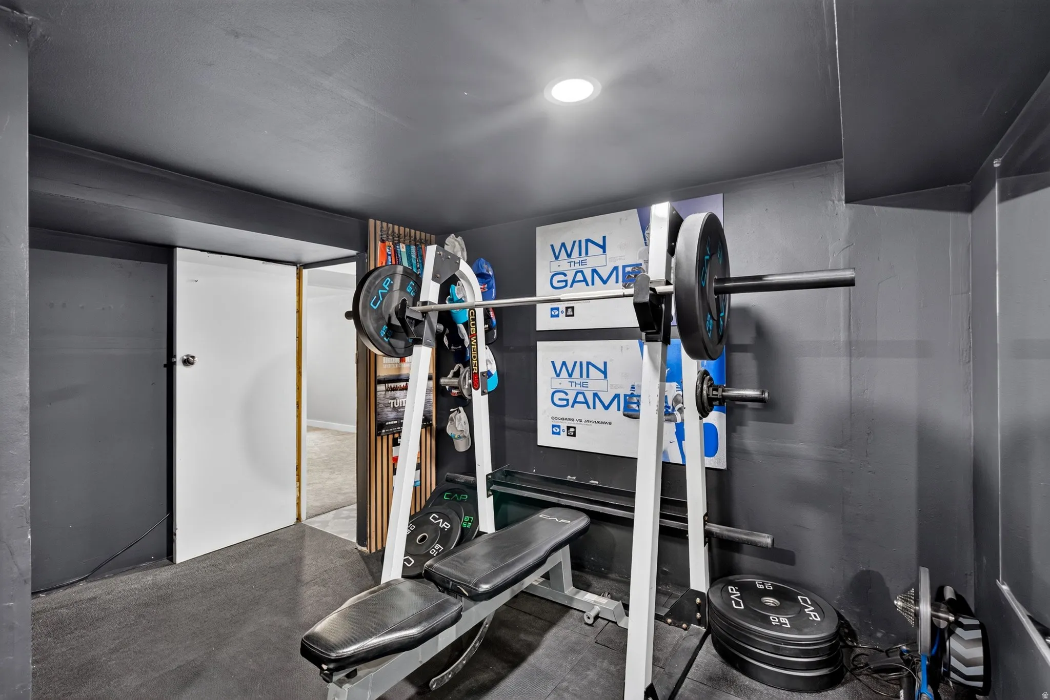 Dedicated fitness space featuring dark gray walls and a complementary dark ceiling